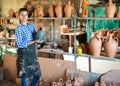 Girl inspecting black ceramic bottle