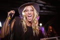 Portrait of cheerful female singer performing at nightclub Royalty Free Stock Photo