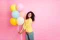 Portrait of cheerful funky mulatto youth girl hold many balons feel content on her birthday 8-march wear trendy clothes