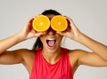 Portrait of cheerful funny and attractive woman holding sliced orange over her eyes Royalty Free Stock Photo