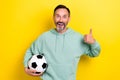 Portrait of cheerful funny bearded man raise hand thumb up satisfied cool game party isolated on yellow color background