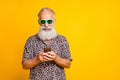 Portrait of cheerful funny funky old bearded man use his cell phone chat on summer holidays vacation wear green Royalty Free Stock Photo