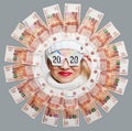 Portrait of a cheerful girl in glasses with the inscription 2020 in the center of the circle of five thousand bills.