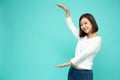 Portrait of a cheerful girl holding blank copy space