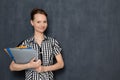 Portrait of cheerful girl holding colored folders in hands and smiling Royalty Free Stock Photo