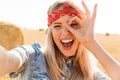 Portrait of cheerful girl 20s laughing and taking selfie while w Royalty Free Stock Photo