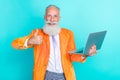 Portrait of cheerful grandfather hold netbook demonstrate thumb up isolated on turquoise color background Royalty Free Stock Photo