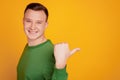 Portrait of cheerful handsome guy toothy smile indicate thumb empty space on yellow background Royalty Free Stock Photo