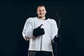 Handsome hockey player. Smiling at camera isolated on black background.