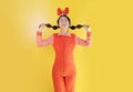 Portrait of cheerful happy asian girl wearing christmas deer costume standing isolated on yellow background, copy space. Royalty Free Stock Photo