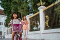 A portrait of a cheerful and happy little girl playing a bicycle in the park Royalty Free Stock Photo