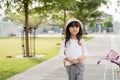 A portrait of a cheerful and happy little girl playing a bicycle in the park Royalty Free Stock Photo