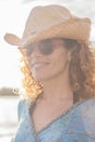 Portrait of cheerful happy middle age adult woman outdoor smiling and enjoying - young caucasian female people with hat and Royalty Free Stock Photo