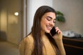 Portrait of cheerful happy pretty young woman talking on phone holding smartphone close to ear. Smiling adult girl using her Royalty Free Stock Photo