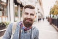 Portrait of a cheerful smiling young man on a city street