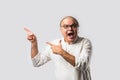 Portrait of cheerful Indian senior old man pointing or presenting or in hands folded pose Royalty Free Stock Photo