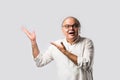 Portrait of cheerful Indian senior old man pointing or presenting or in hands folded pose Royalty Free Stock Photo