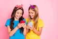 Portrait of cheerful kids laughing hold gadgets look funny information wear trendys tylish t-shirt headbands isolated