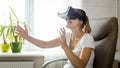 Portrait of cheerful laughing woman wearing VR helmet trying to catch something in air Royalty Free Stock Photo