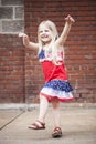 Portrait of cheerful little girl dancing and playing outdoors Royalty Free Stock Photo