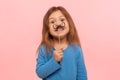 Portrait of cheerful little girl holding paper mustache and smiling to camera, carefree child playing, making funny face