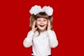 Portrait of cheerful little girl in very big glasses isolated on red. Concept of eyesight or teaching