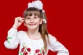 Portrait of cheerful little girl in very big glasses and white bow Royalty Free Stock Photo