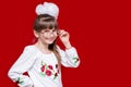 Portrait of cheerful little girl in very big glasses and white bow Royalty Free Stock Photo