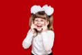Portrait of cheerful little girl in very big glasses and white bow Royalty Free Stock Photo