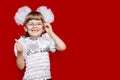 Portrait of cheerful little girl in very big glasses and white bows show thumb up Royalty Free Stock Photo