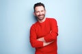 Cheerful man with beard posing against blue background