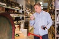 Portrait of cheerful man buying wine Royalty Free Stock Photo