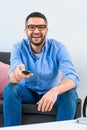 portrait of cheerful man changing channels while watching tv Royalty Free Stock Photo