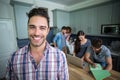 Portrait of cheerful man with friends in background Royalty Free Stock Photo