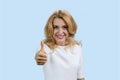 Portrait of a cheerful mature caucasian blond woman gives her thumb up. Royalty Free Stock Photo