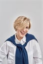 Portrait of cheerful middle aged caucasian woman with short hair style wearing business attire, smiling at camera while Royalty Free Stock Photo