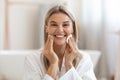 portrait of cheerful middle aged woman using cotton pads Royalty Free Stock Photo