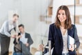 Portrait of cheerful modern female professional in modern office Royalty Free Stock Photo