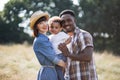 Cheerful multicultural parents hugging little son outdoors Royalty Free Stock Photo