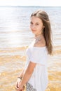 Cheerful natural young girl with long hair on water sand sea beach Royalty Free Stock Photo