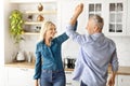 Portrait Of Cheerful Older Couple Dancing Together In Kitchen Interior Royalty Free Stock Photo