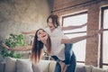 Portrait of cheerful parent kid laughing wearing white t-shirt denim jeans looking standing in house indoors