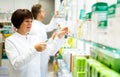 Pharmacist and pharmacy technician posing in drugstore Royalty Free Stock Photo