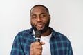 Portrait of cheerful positive chic handsome african man holding microphone singing song. Isolated on white background. Royalty Free Stock Photo