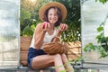 Portrait cheerful pretty happy smiling young female farmer enjoy hold in hand basket ripe tomato homegrown harvest local