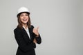 Portrait of a cheerful pretty woman in hard hat and suit Royalty Free Stock Photo