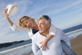 Portrait of cheerful senior couple on the beach having fun