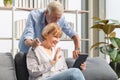 Portrait of Cheerful senior couple in living room, Mature woman and senior man using smartphone talking on video call on cozy sofa Royalty Free Stock Photo