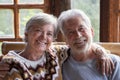 Portrait of cheerful senior couple looking on camera and embracing each other. Old age lifestyle people happiness concept with man Royalty Free Stock Photo