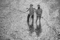 Portrait of cheerful senior man fishing. Grandfather and son fishermans. Young man and an old man fishing for spinnings Royalty Free Stock Photo